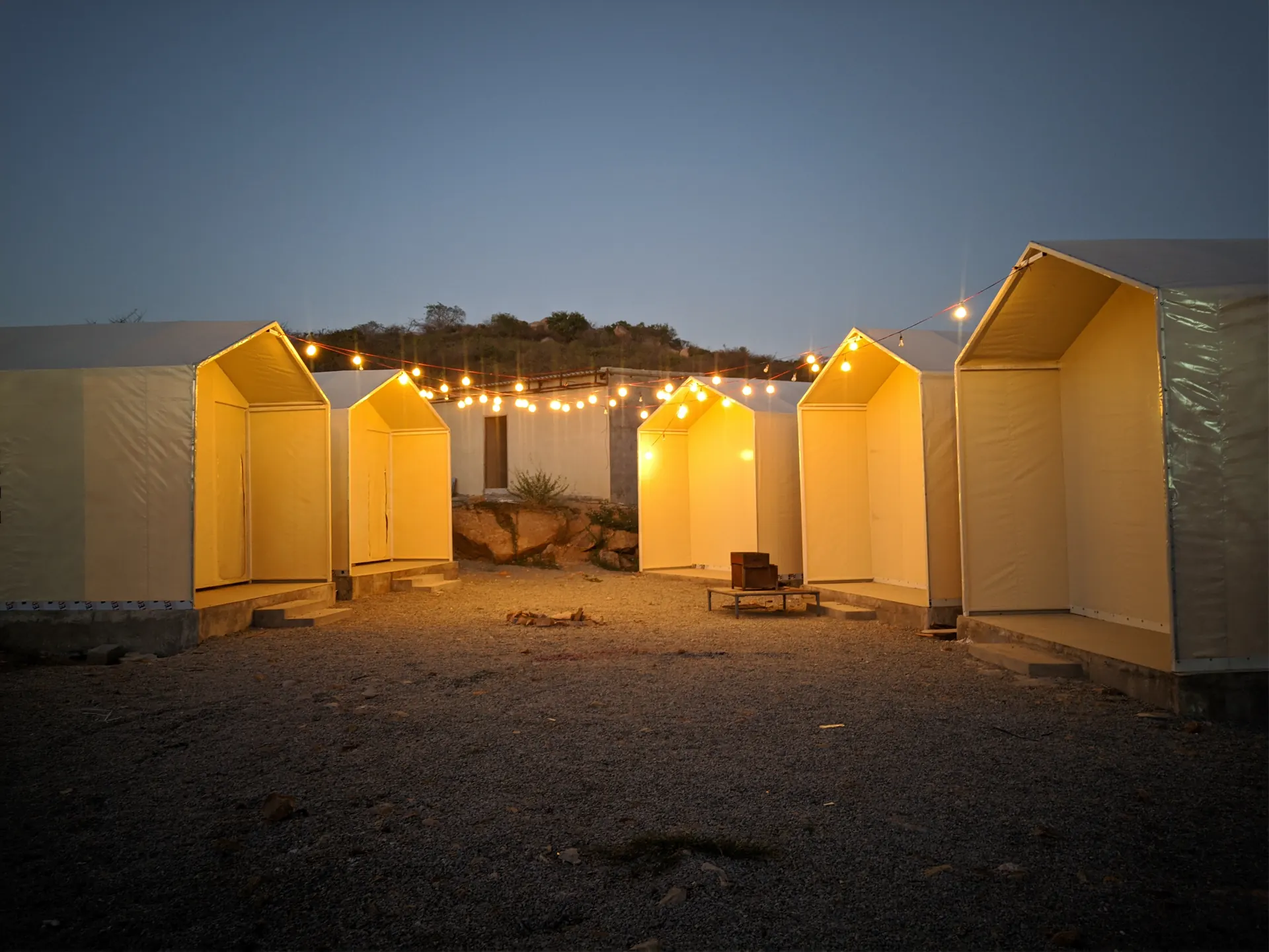 Fairy-lit cabins at Keesara at dusk