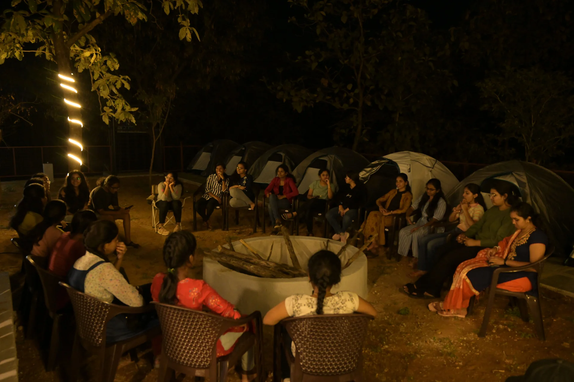 Group in a facilitated circle around a firepit